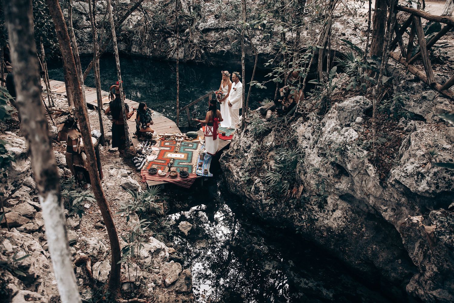 A romantic photoshoot in a lush forest setting with moody lighting and natural scenery.