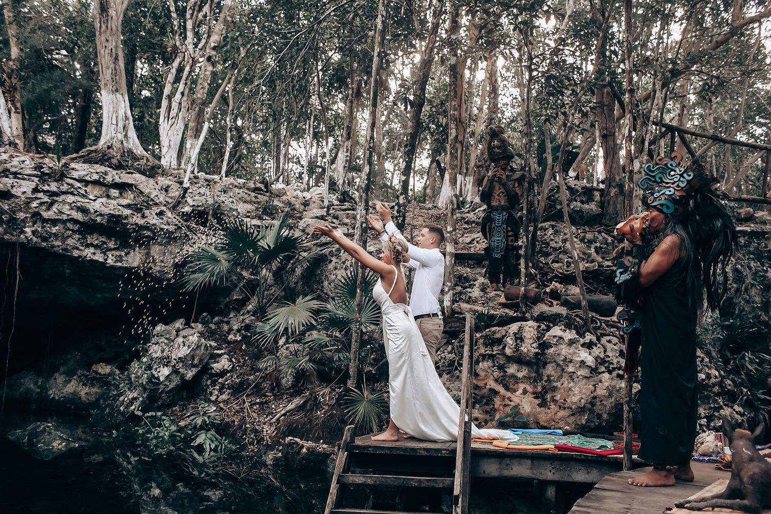 An intimate moment captured against a backdrop of trees and rocks in a natural setting.
