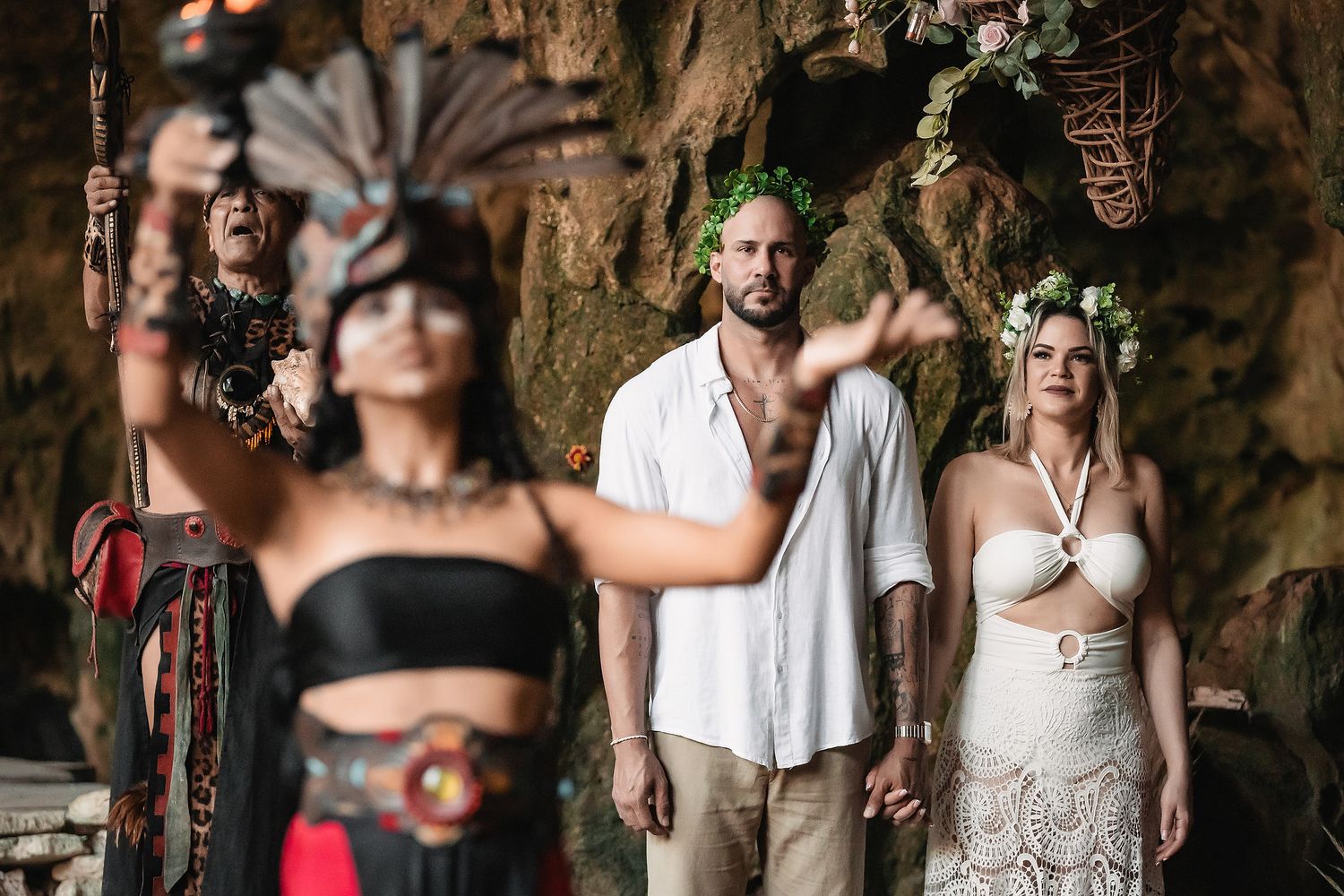 Mayan cenote wedding ceremony with a couple and traditional dancers in Tulum