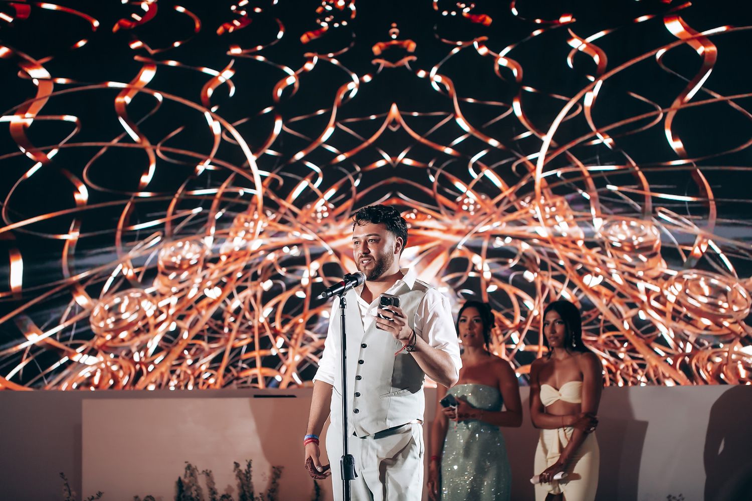 Wedding venue decorated with stunning red light effects and confetti patterns.