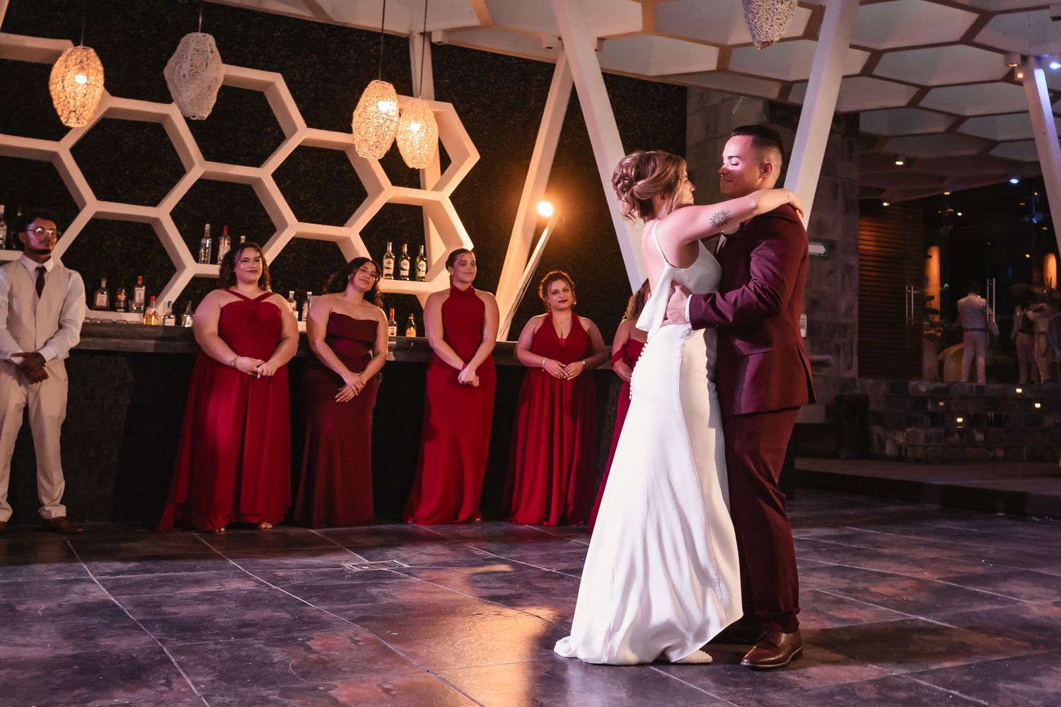 Wedding reception dance floor with unique honeycomb ceiling pattern and mood lighting.