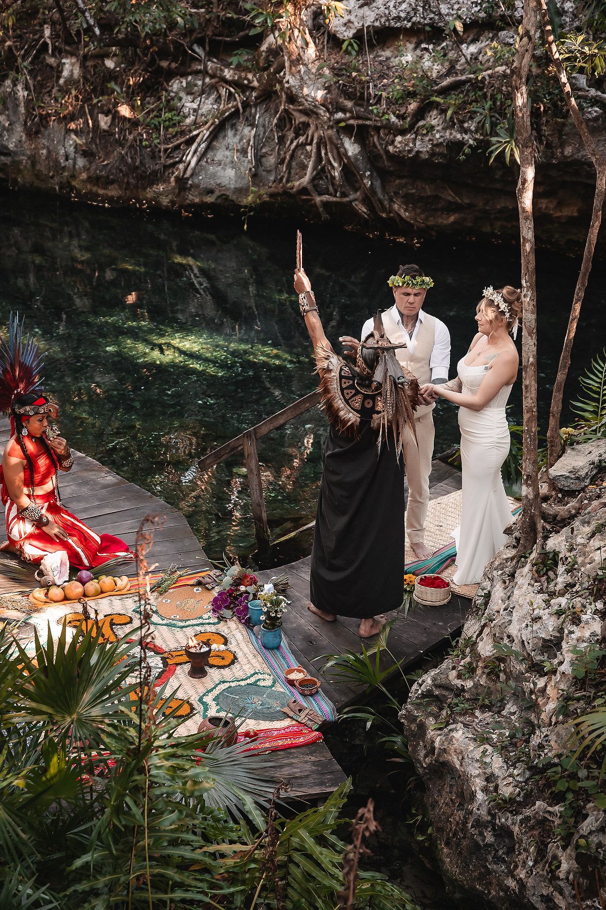 Aerial view of a traditional Mayan wedding ceremony in a scenic cenote location.