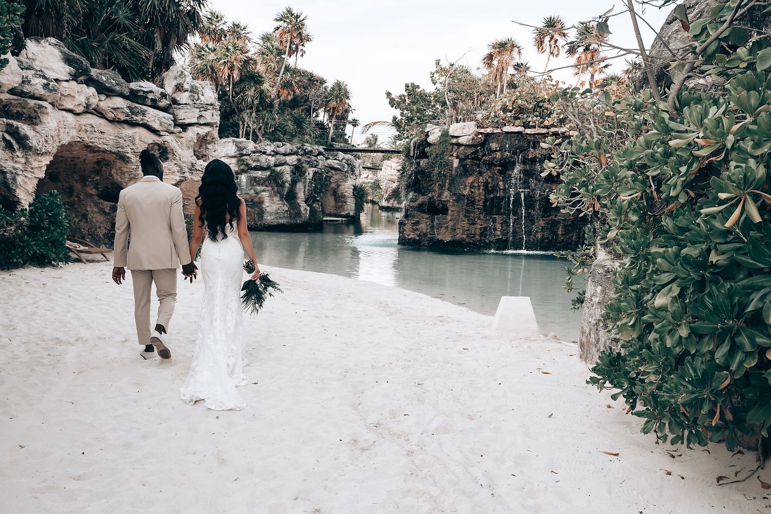 Beachside wedding venue with stone walls and tropical landscaping.