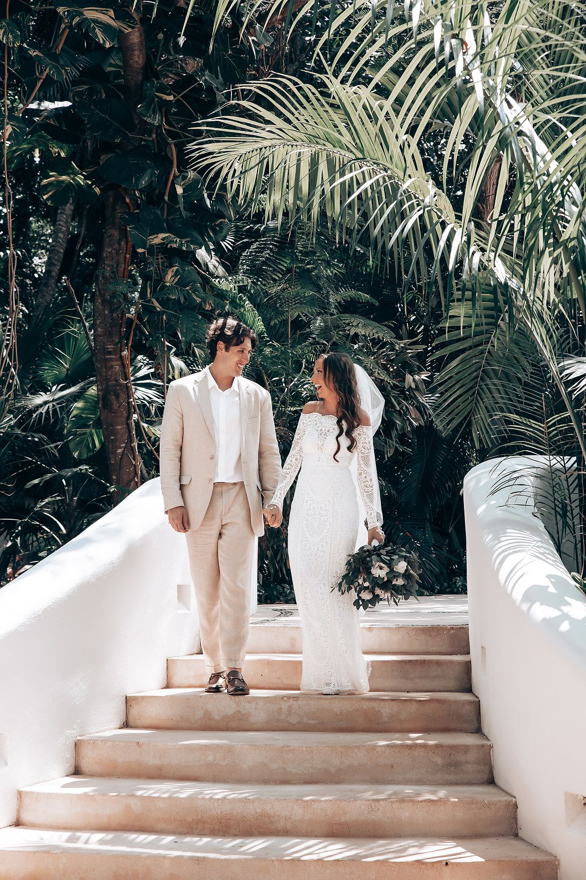 Bride and groom portrait in tropical garden at Mahekal Beach Resort