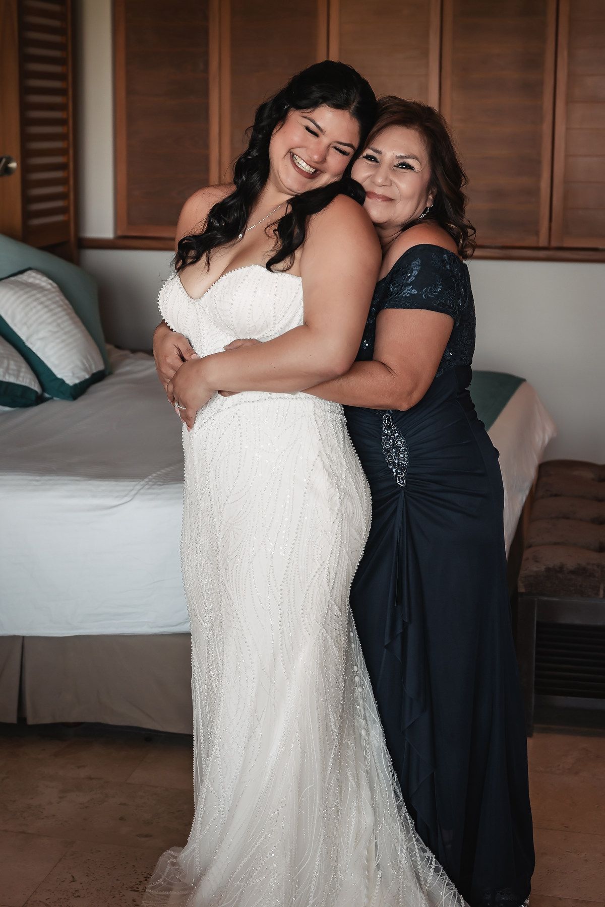 Tender embrace between two people in formal wedding attire.