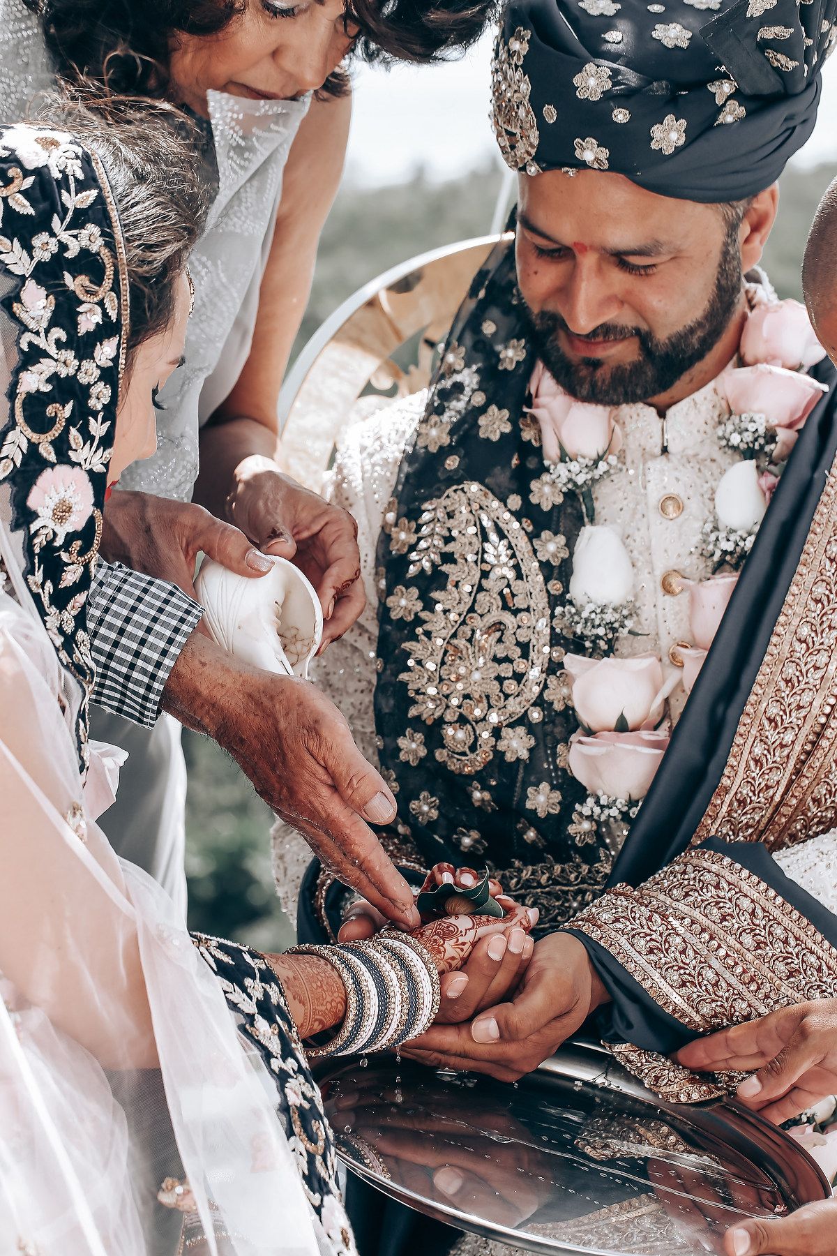 Close-up shots showing hands exchanging rings during a traditional South Asian wedding ceremony.