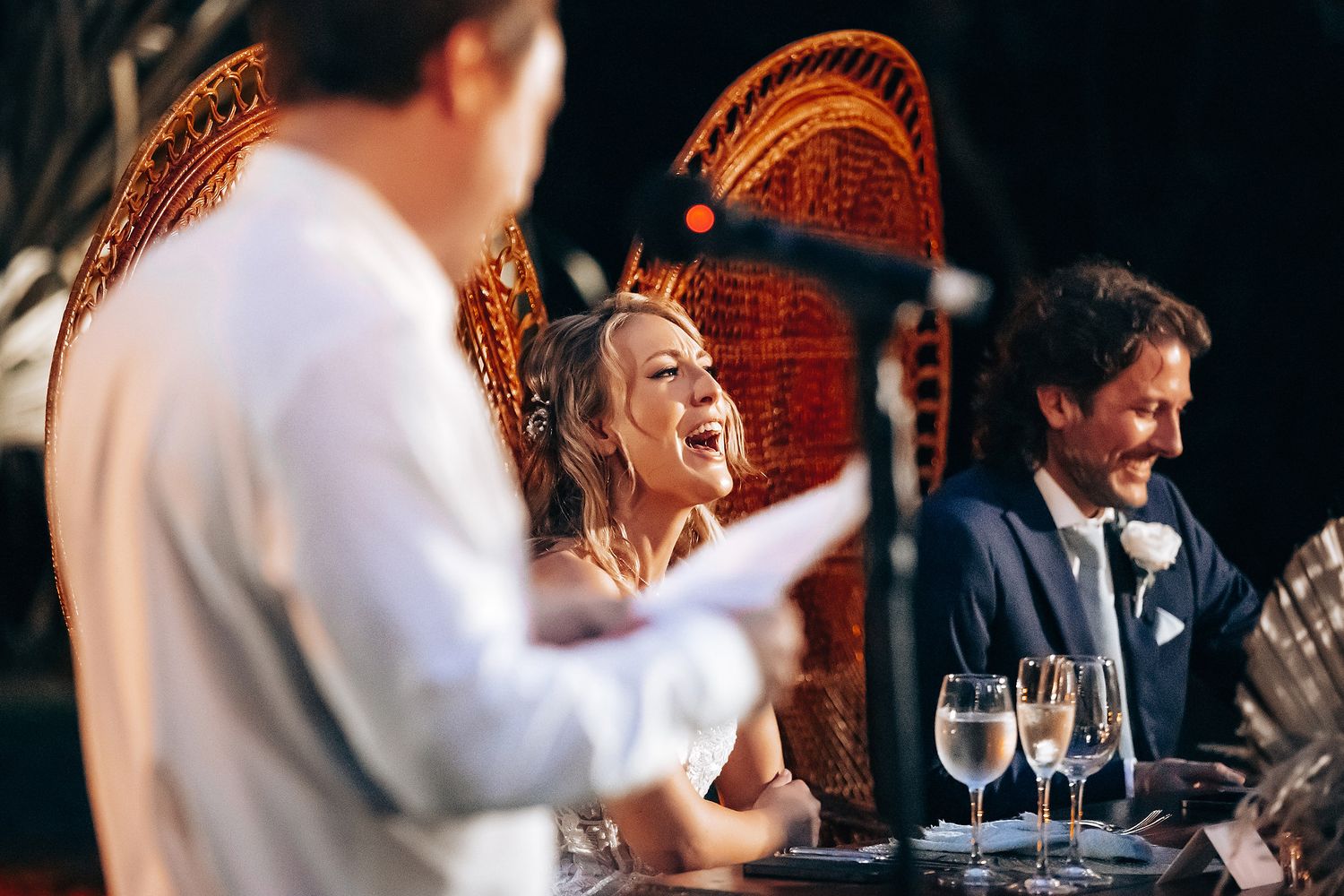 Wedding reception moment captured in warm lighting with ornate decor.