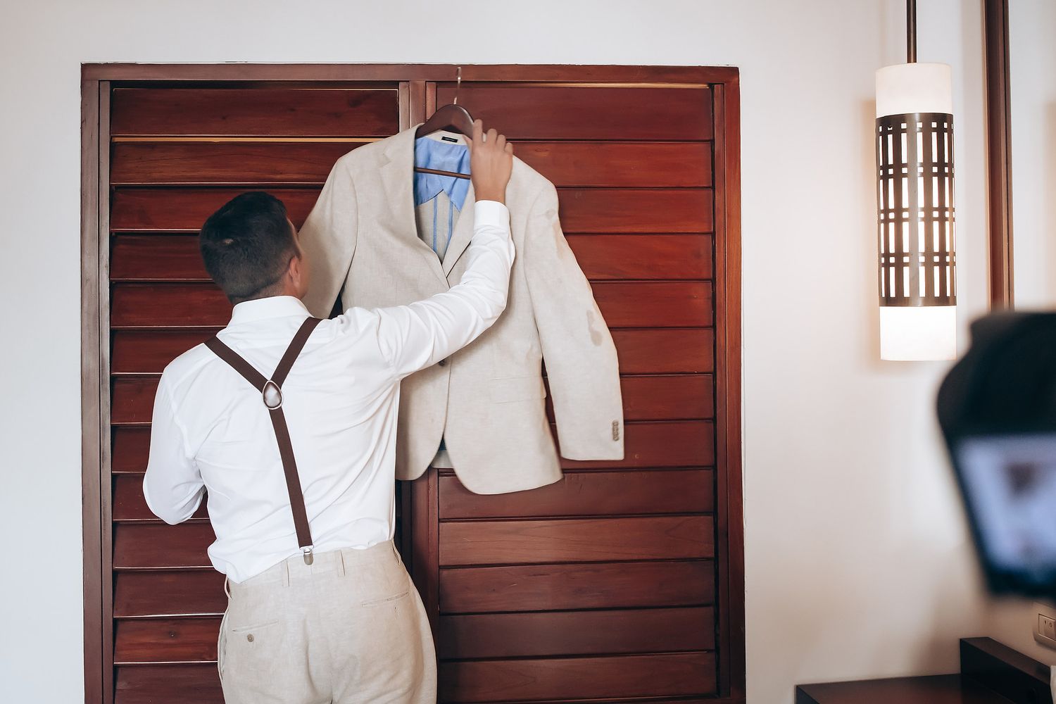 A series of photos showing a white suit jacket and brown wooden door in different compositions and angles.