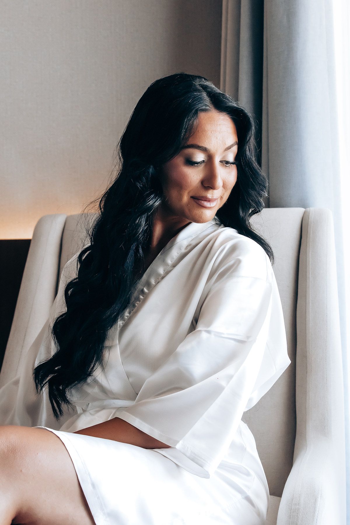Artistic boudoir photography series showing a person in white robe by a window with soft natural lighting.