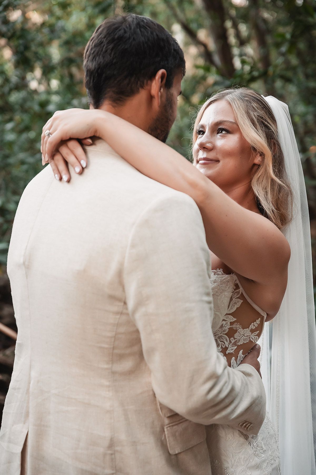Romantic wedding couple portraits showing intimate embraces in a natural setting.