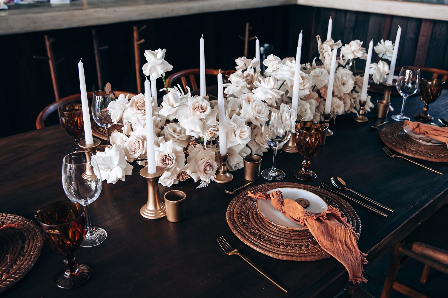 Elegant table settings with white floral centerpieces and copper charger plates.