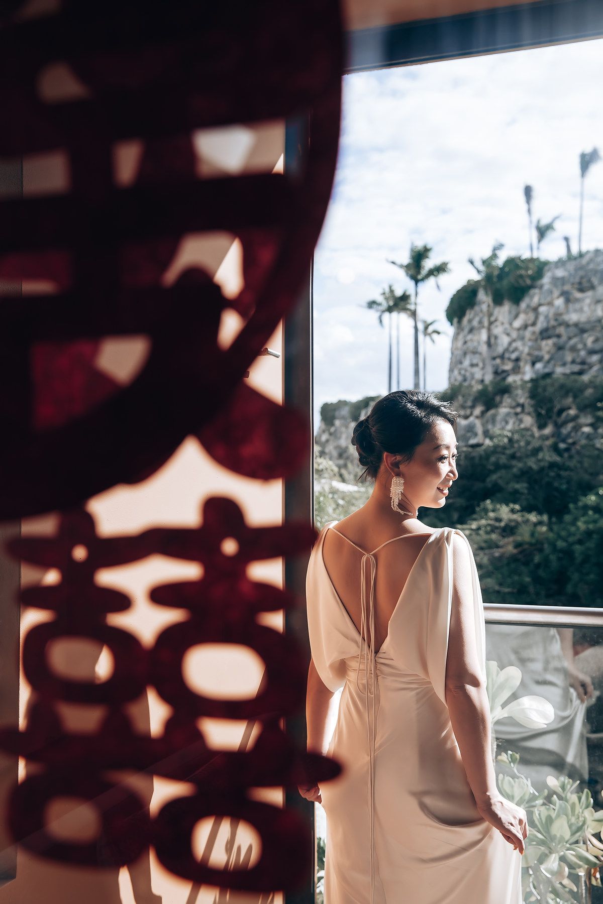 A series of artistic photos showing a person in a white dress looking out windows with decorative shadows.