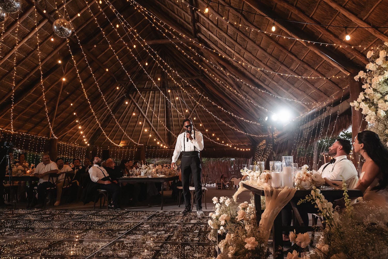 Wedding reception venue decorated with twinkling string lights creating a magical atmosphere.