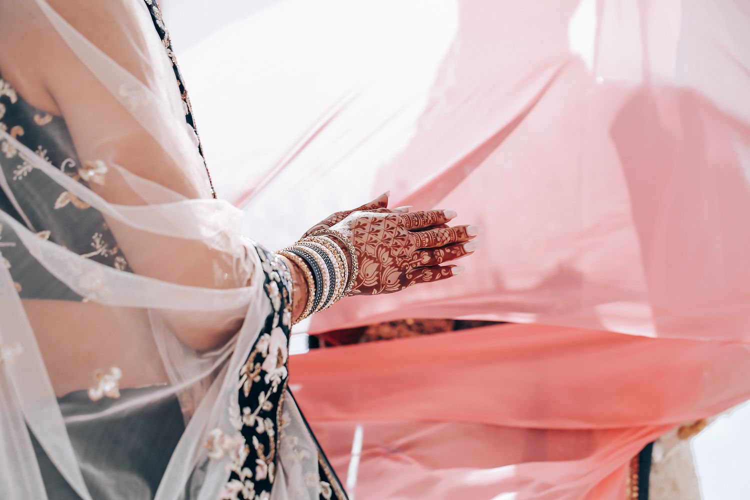 Pink and white balloons float against a light background creating a soft, dreamy party atmosphere.