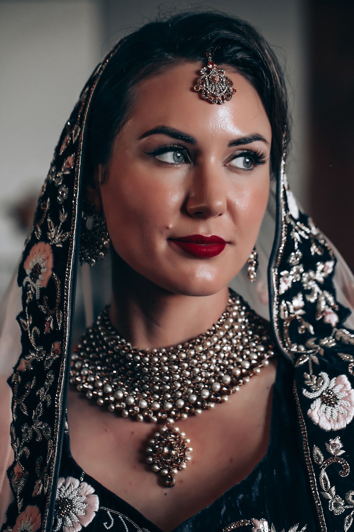 Close-up shots of traditional Indian bridal jewelry featuring ornate necklaces and headpieces with intricate beadwork.