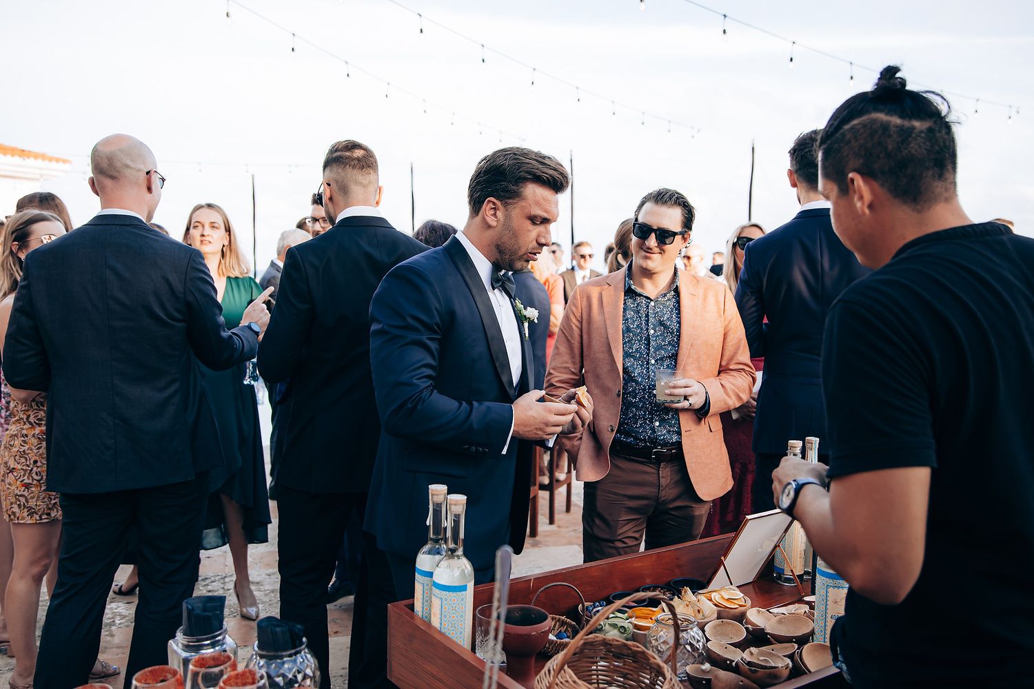 People mingling and socializing at an elegant cocktail party or reception with drinks in hand.