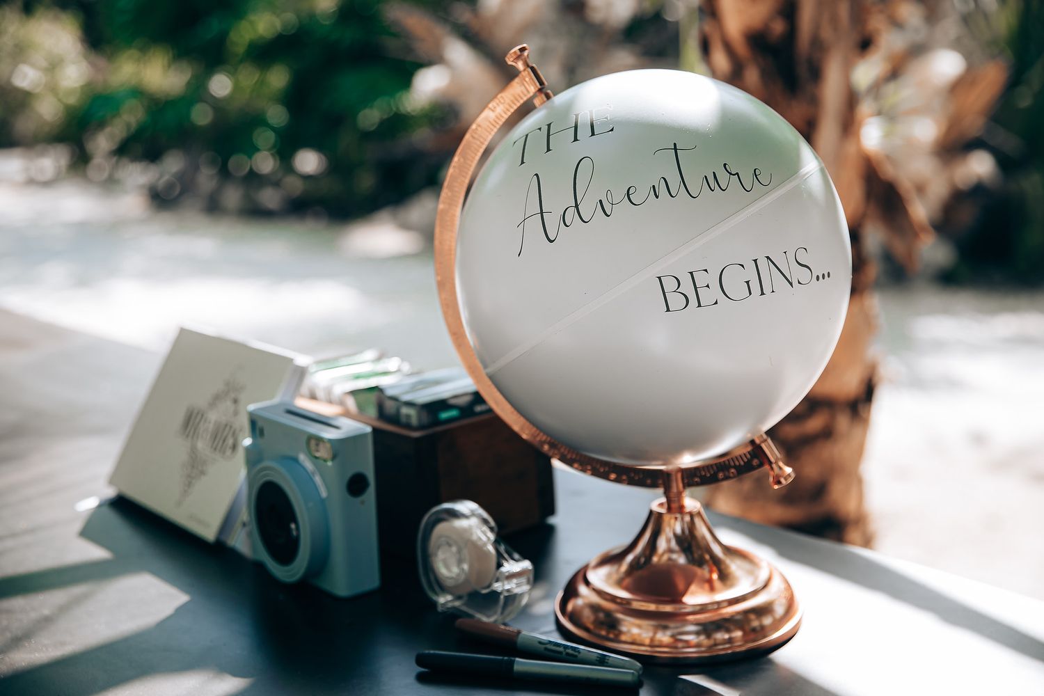 Elegant wedding place settings with copper details and white eggs used as name cards on a rustic wooden table.