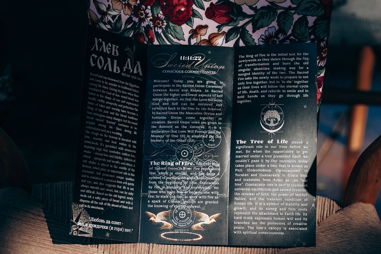 Open pages of a dark wedding program or storybook with elegant typography and romantic text details.