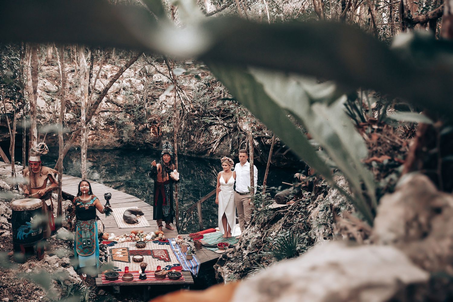 Forest wedding venue with rustic decor and natural lighting filtering through tree canopy.