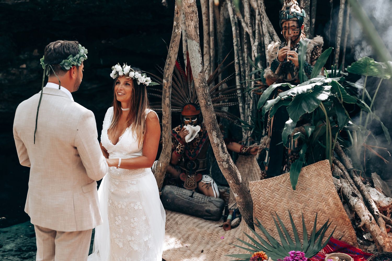 Wedding ceremony taking place in a lush tropical forest setting with natural decor.