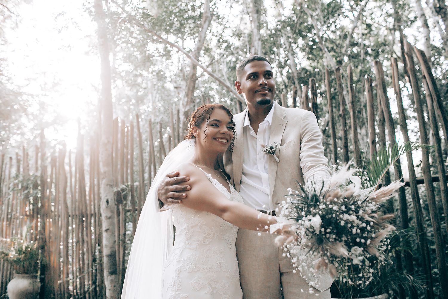 Sunlit wedding celebration captured in a forest setting with natural lighting.