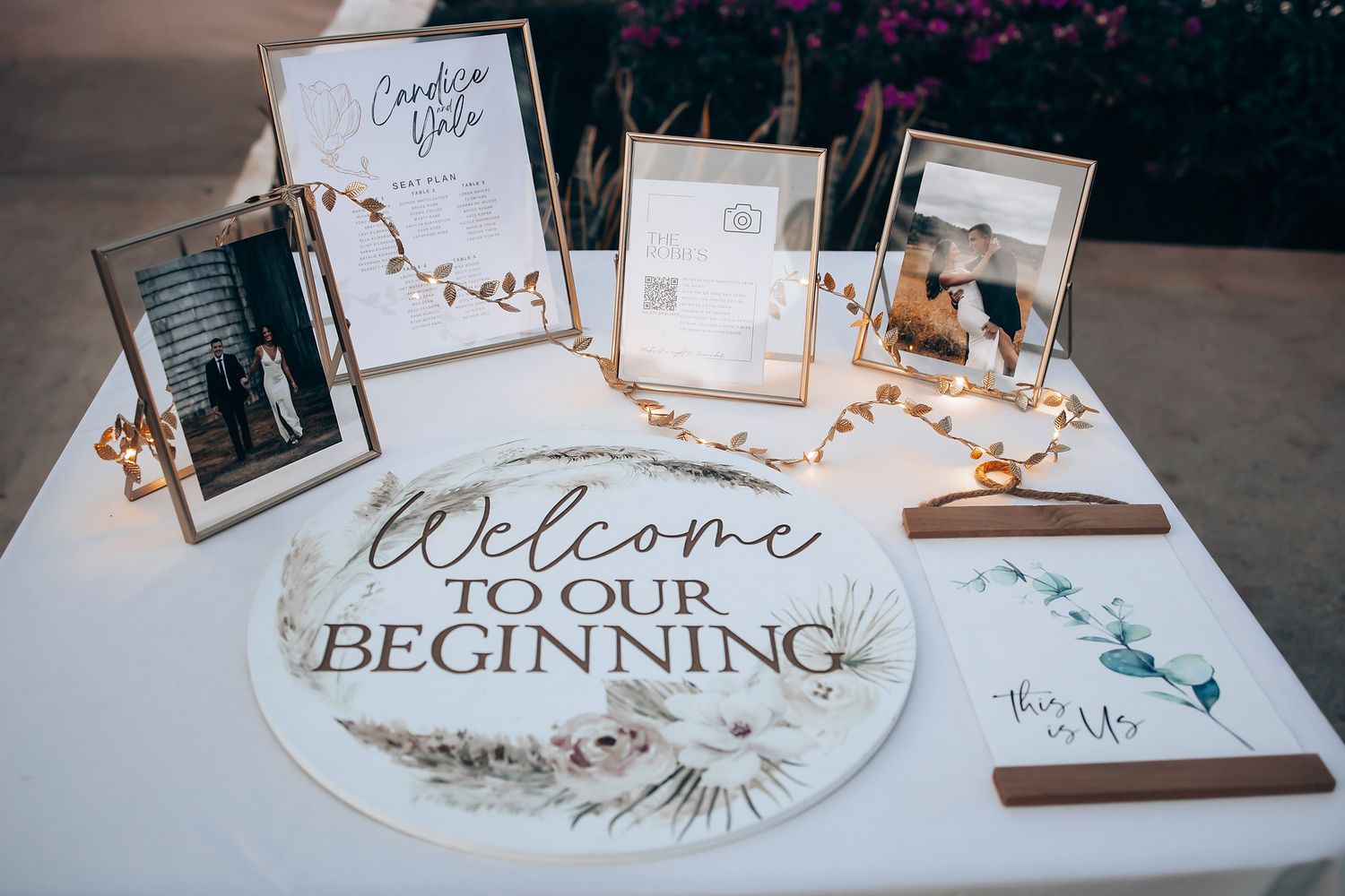 Wedding welcome sign and photo display with rustic wooden frames and calligraphy.