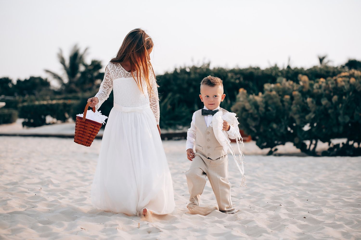 Wedding celebration on a tropical beach with palm trees in the background.