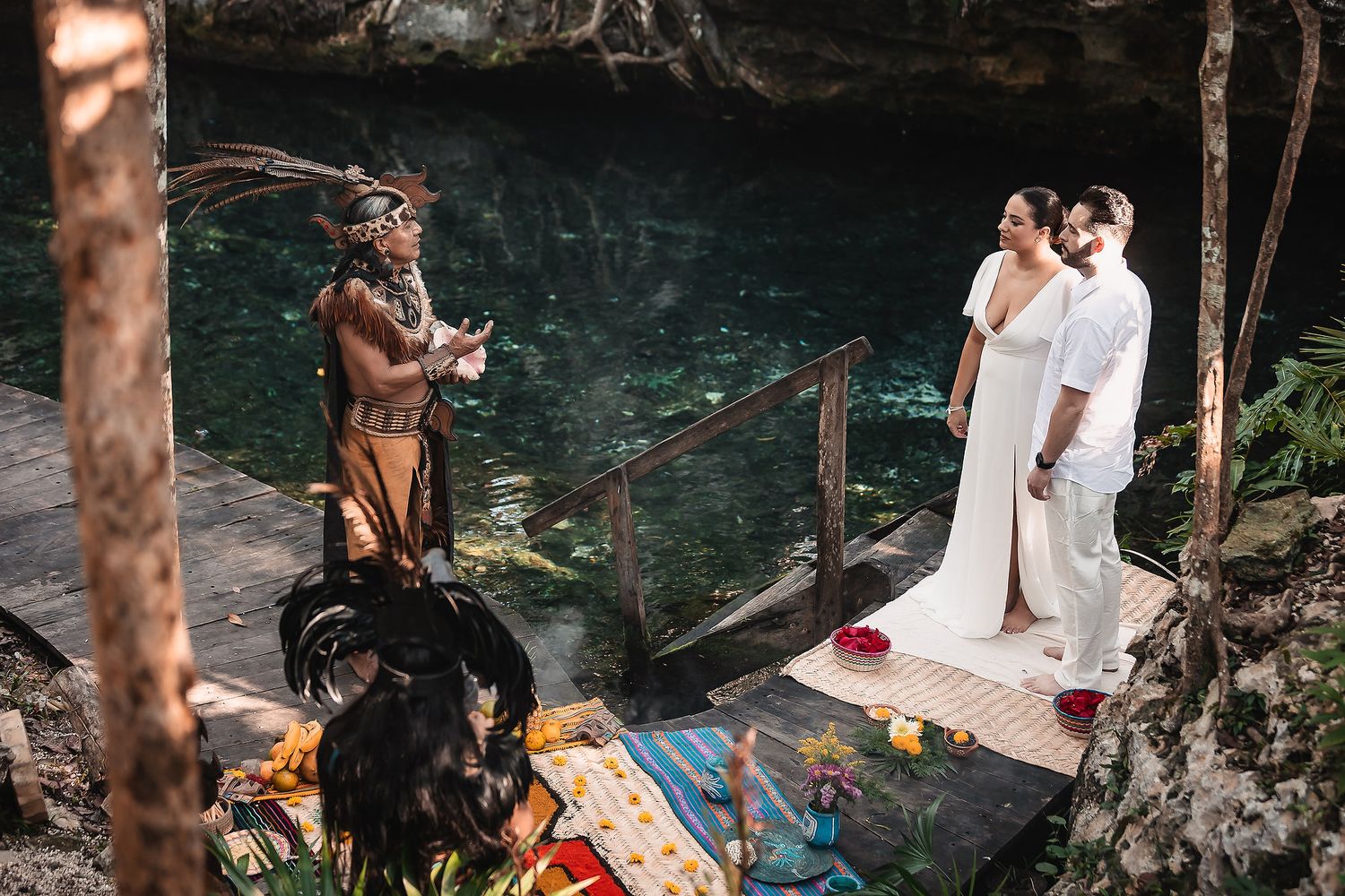 Traditional Mayan ceremony takes place near a cenote with spiritual leaders performing rituals in Mexico.