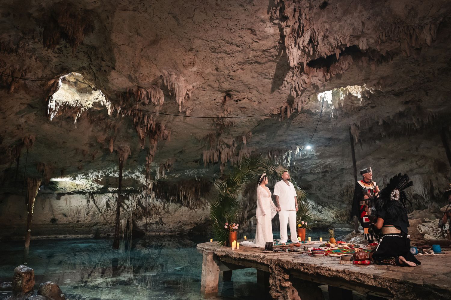 Cave wedding ceremony with natural rock formations and atmospheric lighting creating a magical ambiance.