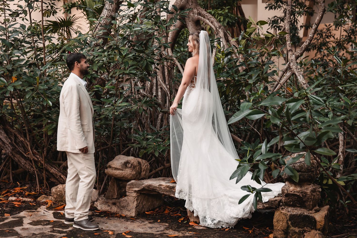 Bride and groom explore a rustic woodland setting during their wedding photoshoot.