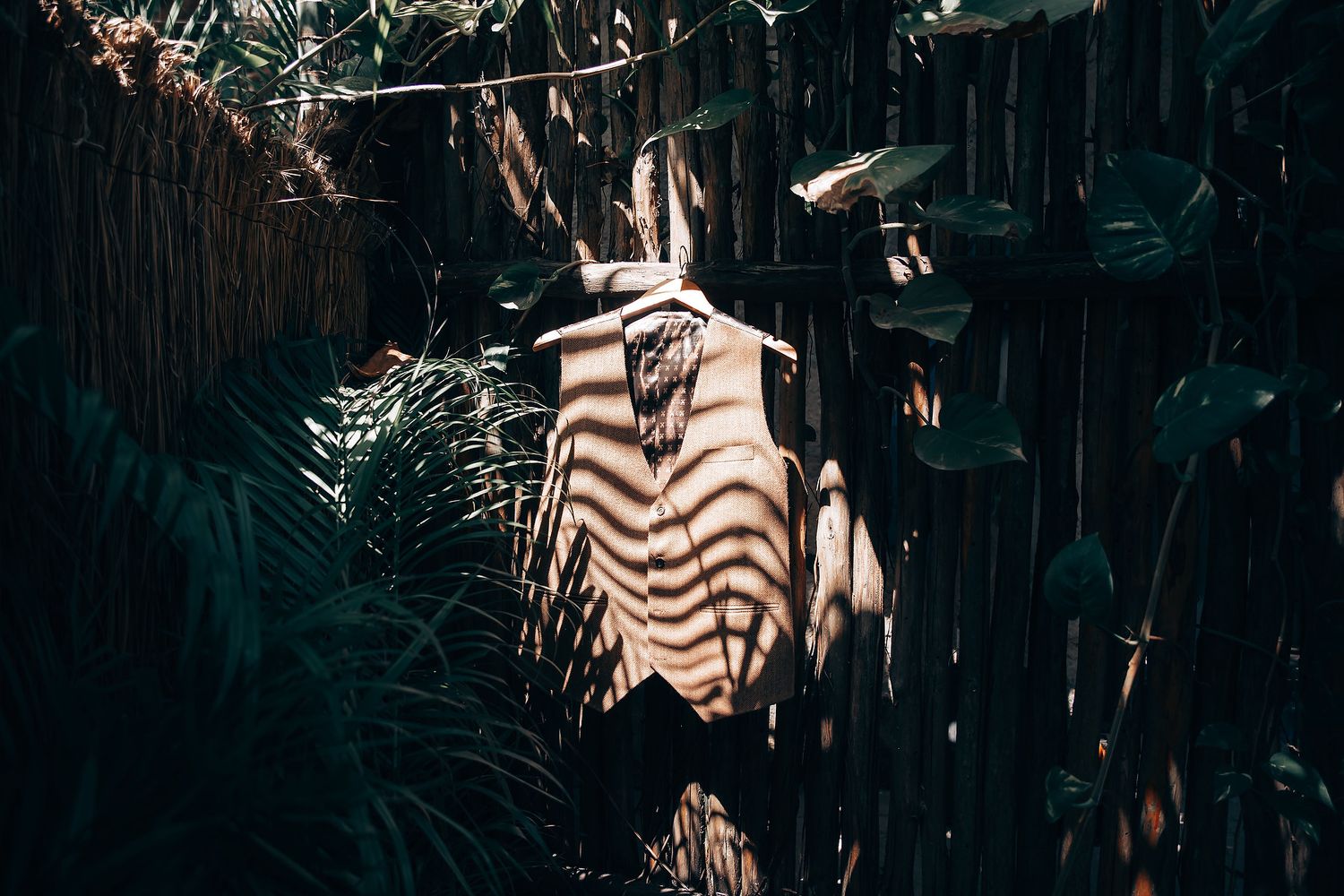 Tropical garden pathway with ambient lighting and palm fronds.