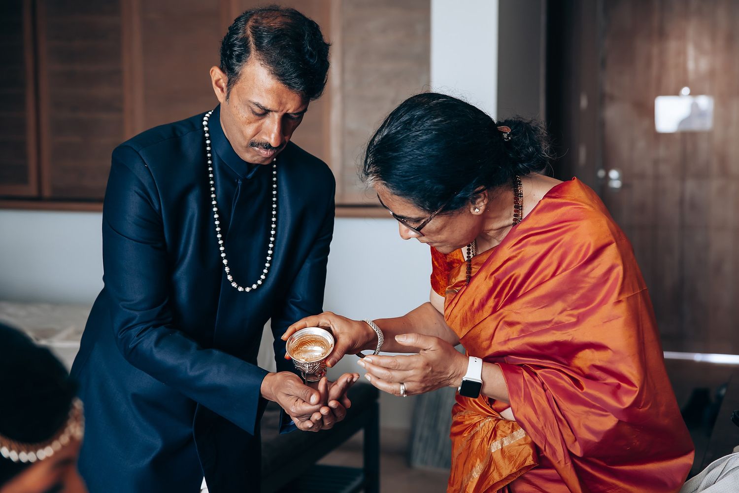 Traditional Indian wedding ceremony with participants in formal attire.