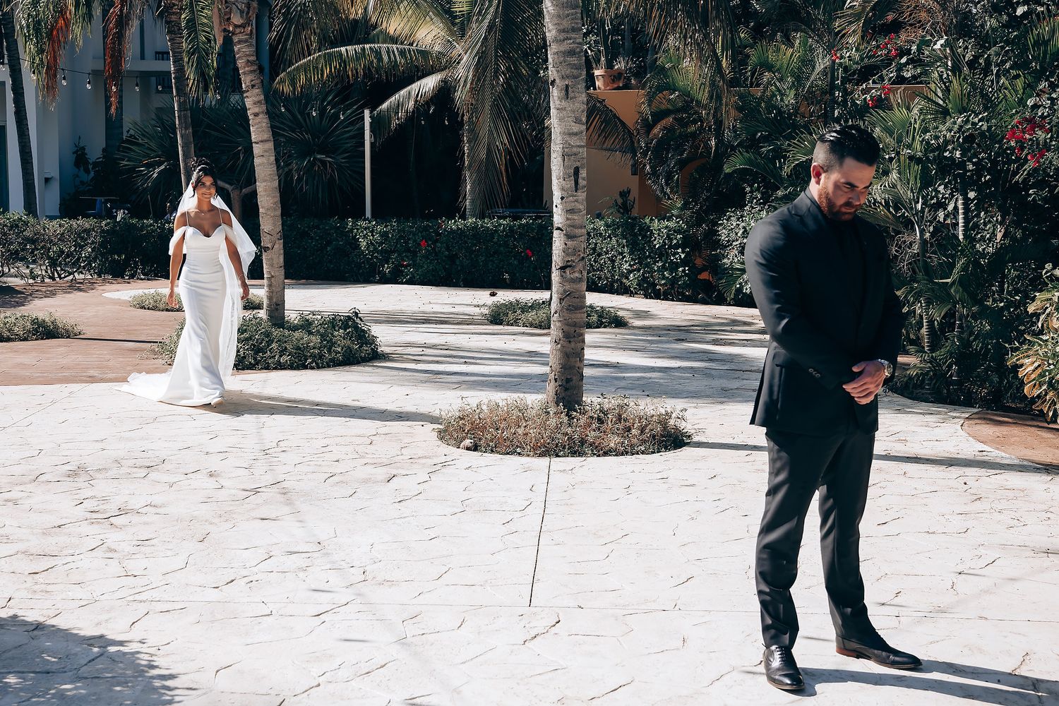 A first look wedding moment captured in a tropical garden setting.