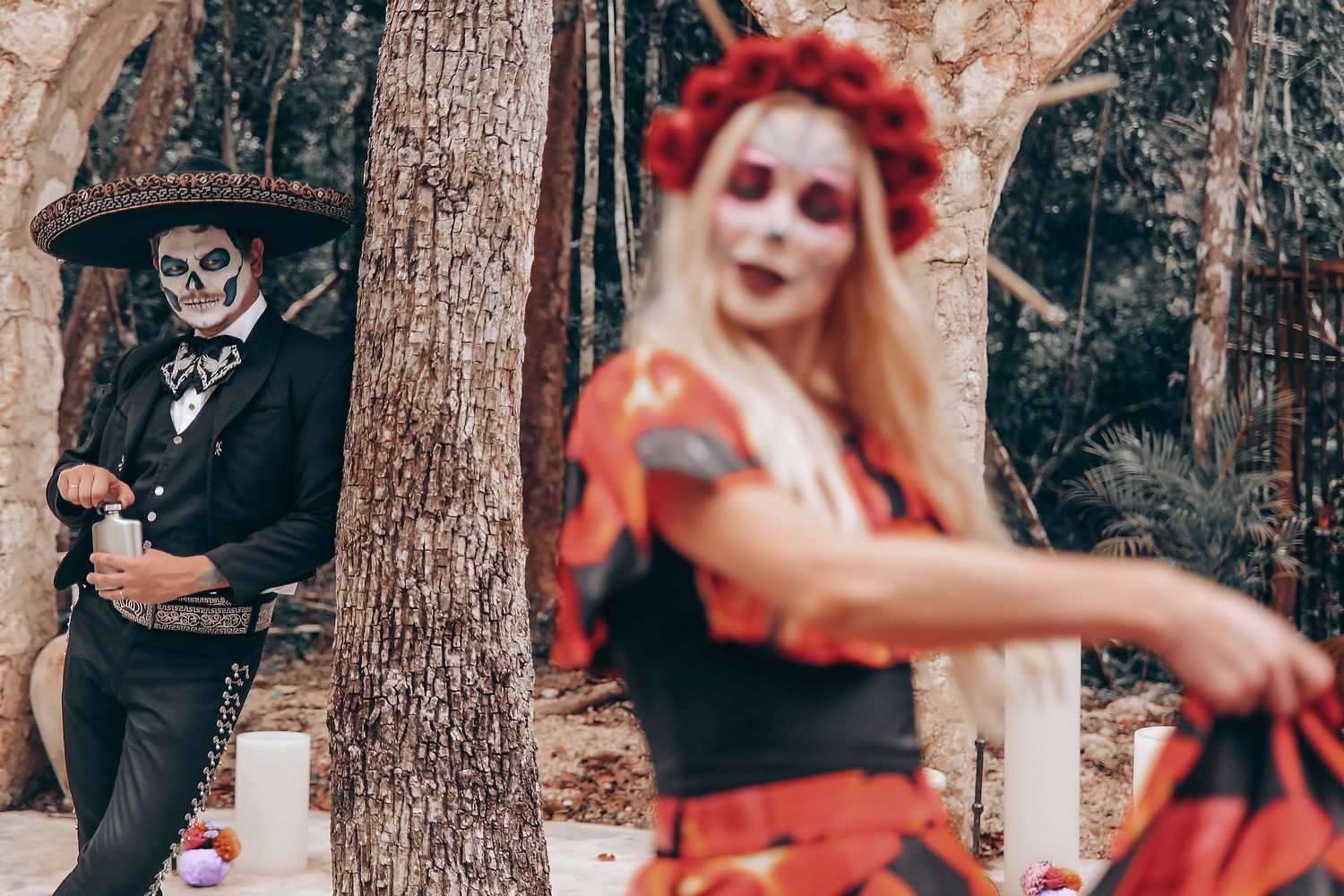 A dramatic dance performance in a forest with red and black costumes creating contrast against natural backdrop.