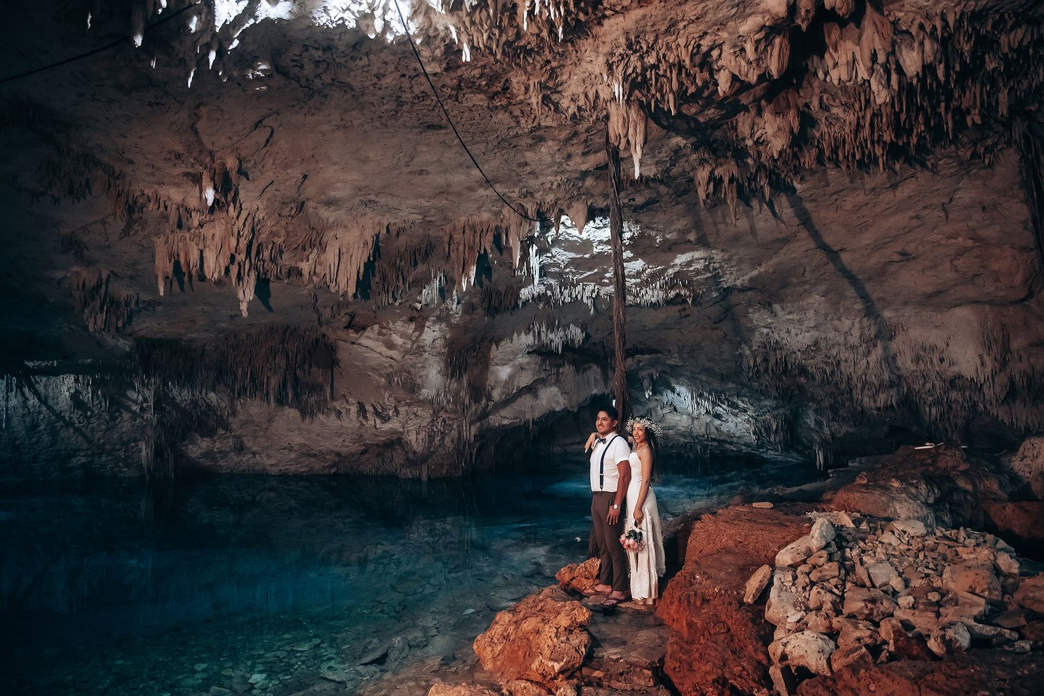 Dimly lit cave interior with natural rock formations and soft candlelight creating an atmospheric ambiance.
