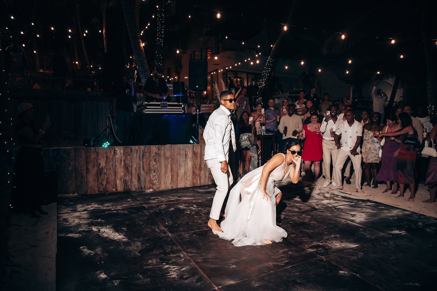 Nighttime wedding celebration with guests holding sparklers creating a magical ambiance.