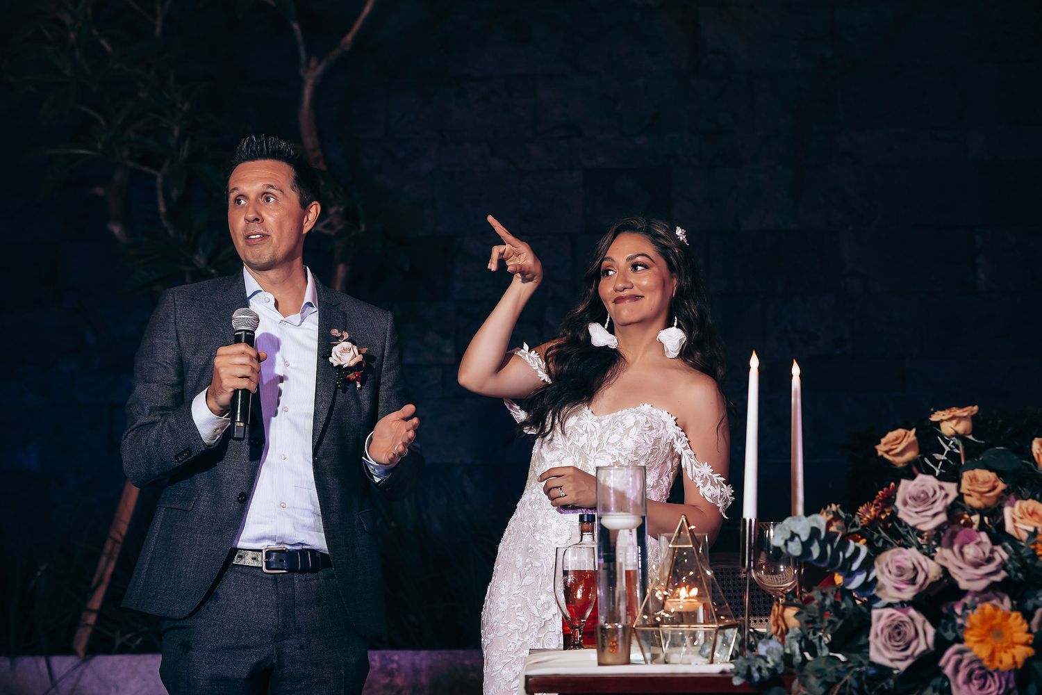 Wedding reception celebration with toasts and candlelit decor.