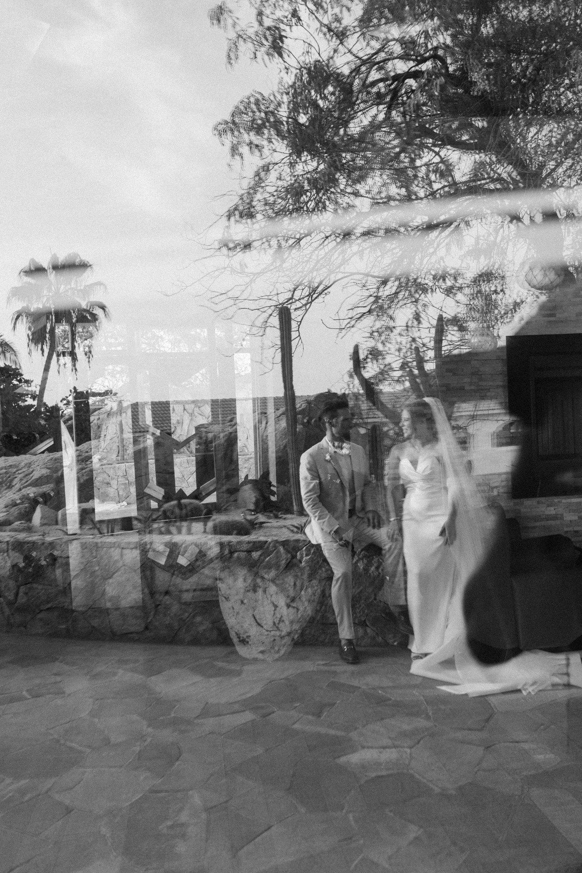 Black and white double exposure photo of bride and groom at a Cabo San Lucas wedding