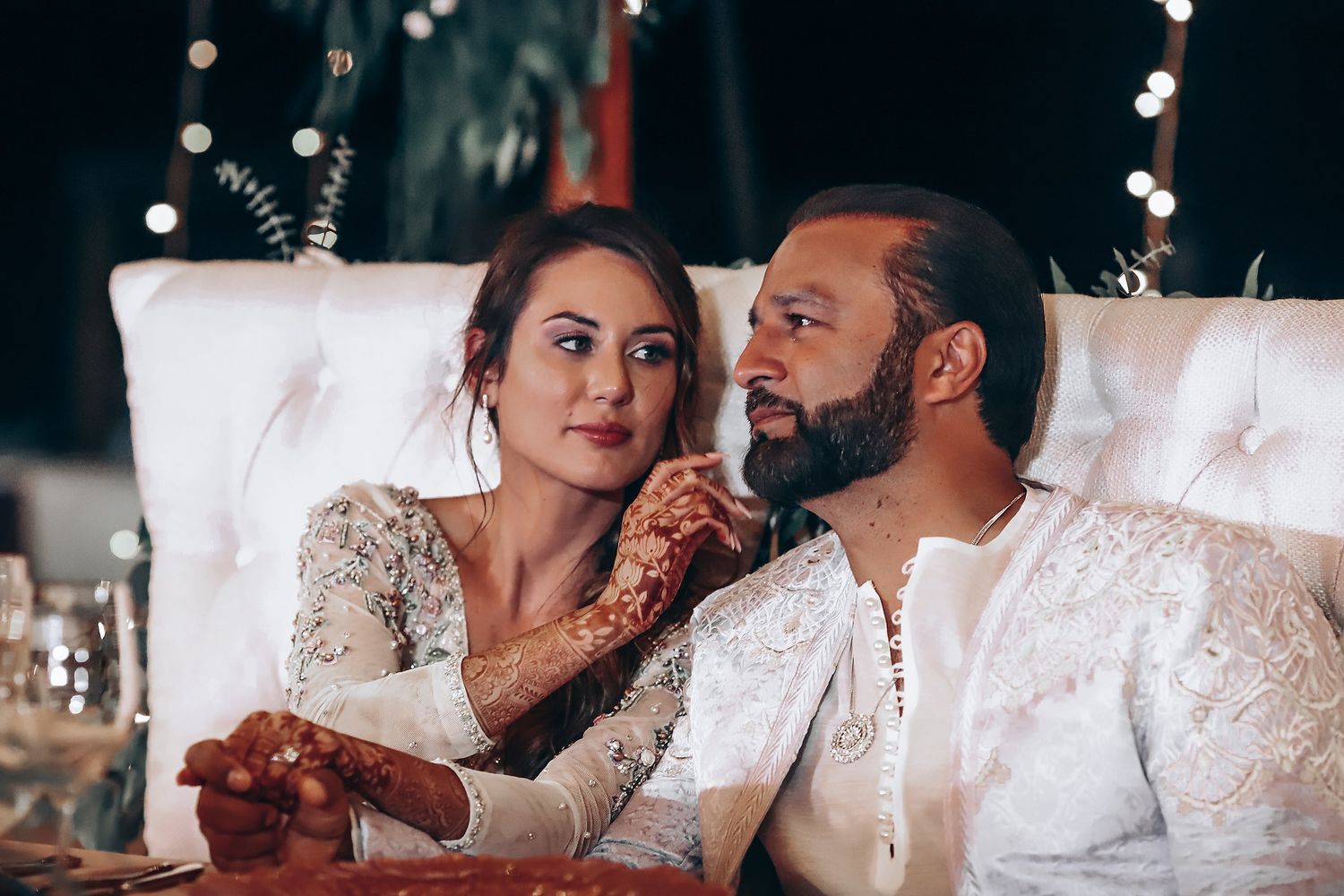 A romantic wedding couple shares intimate moments in a series of candid photographs.