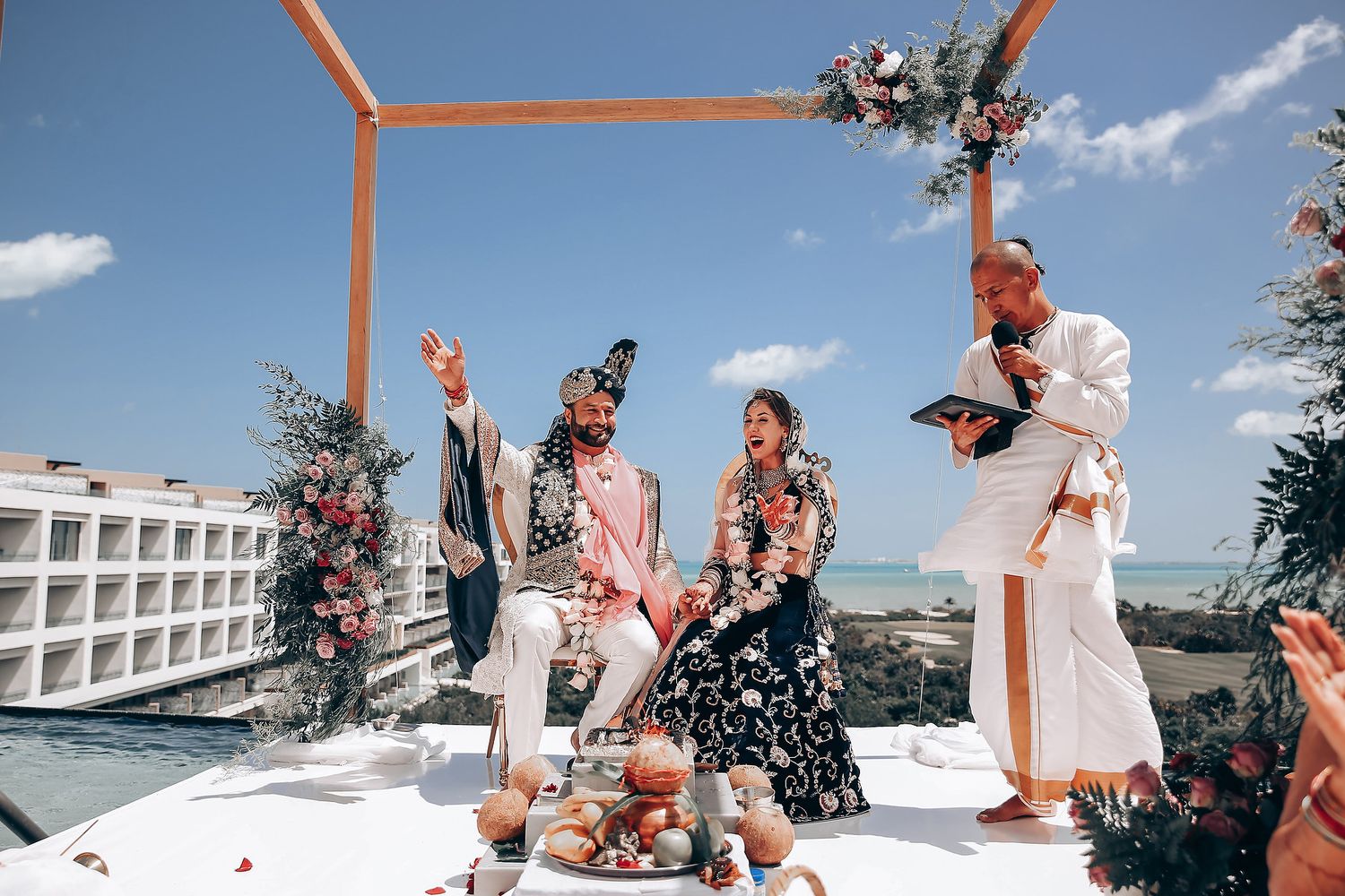 A collection of wedding photos showing joyful moments with a couple and guests against a bright blue sky and white building.