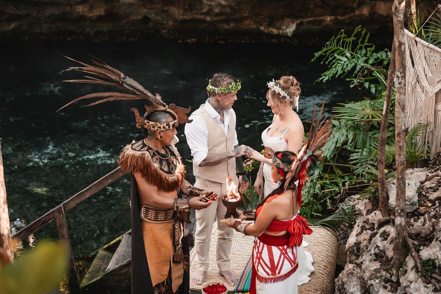 Cultural wedding ceremony taking place in a natural cave setting with traditional elements.