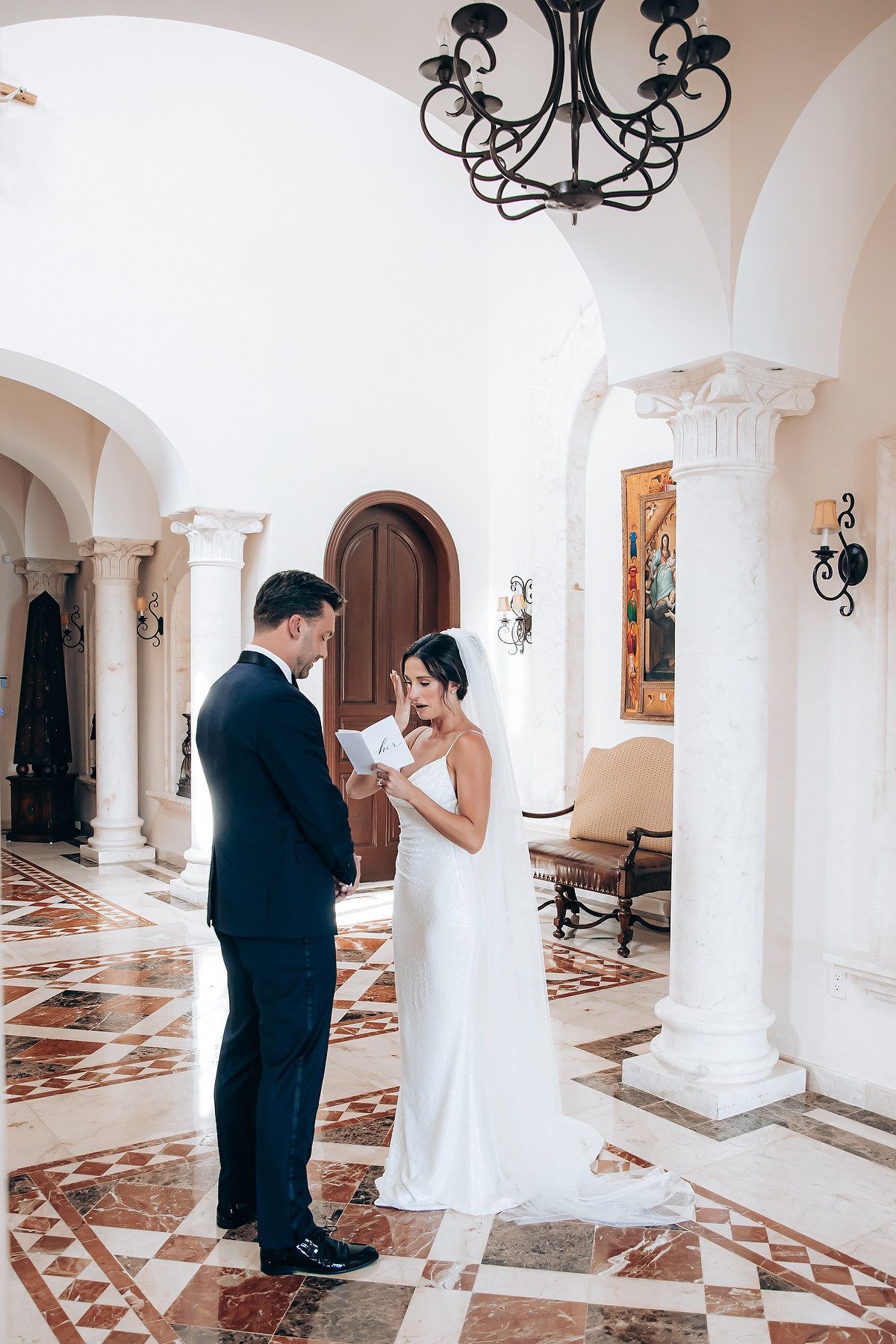 A sequence of romantic wedding photos showing a couple playfully hiding behind white columns in an elegant hallway.