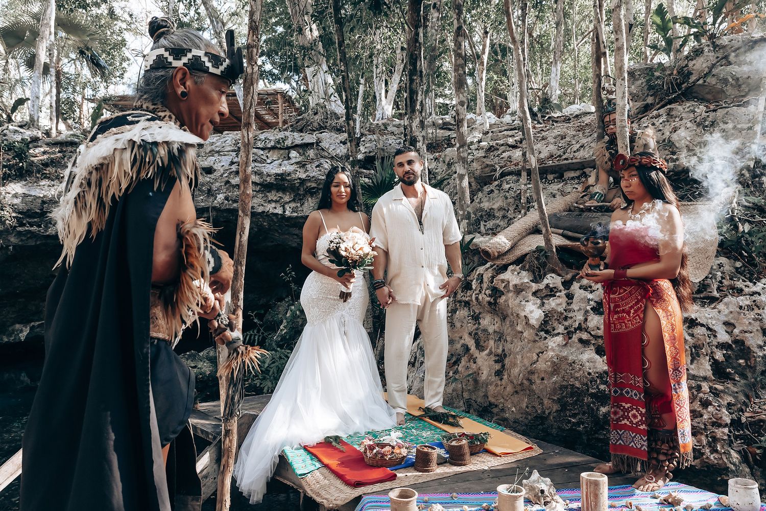 Intimate outdoor wedding ceremony in a rustic woodland setting with stone walls and natural decor.