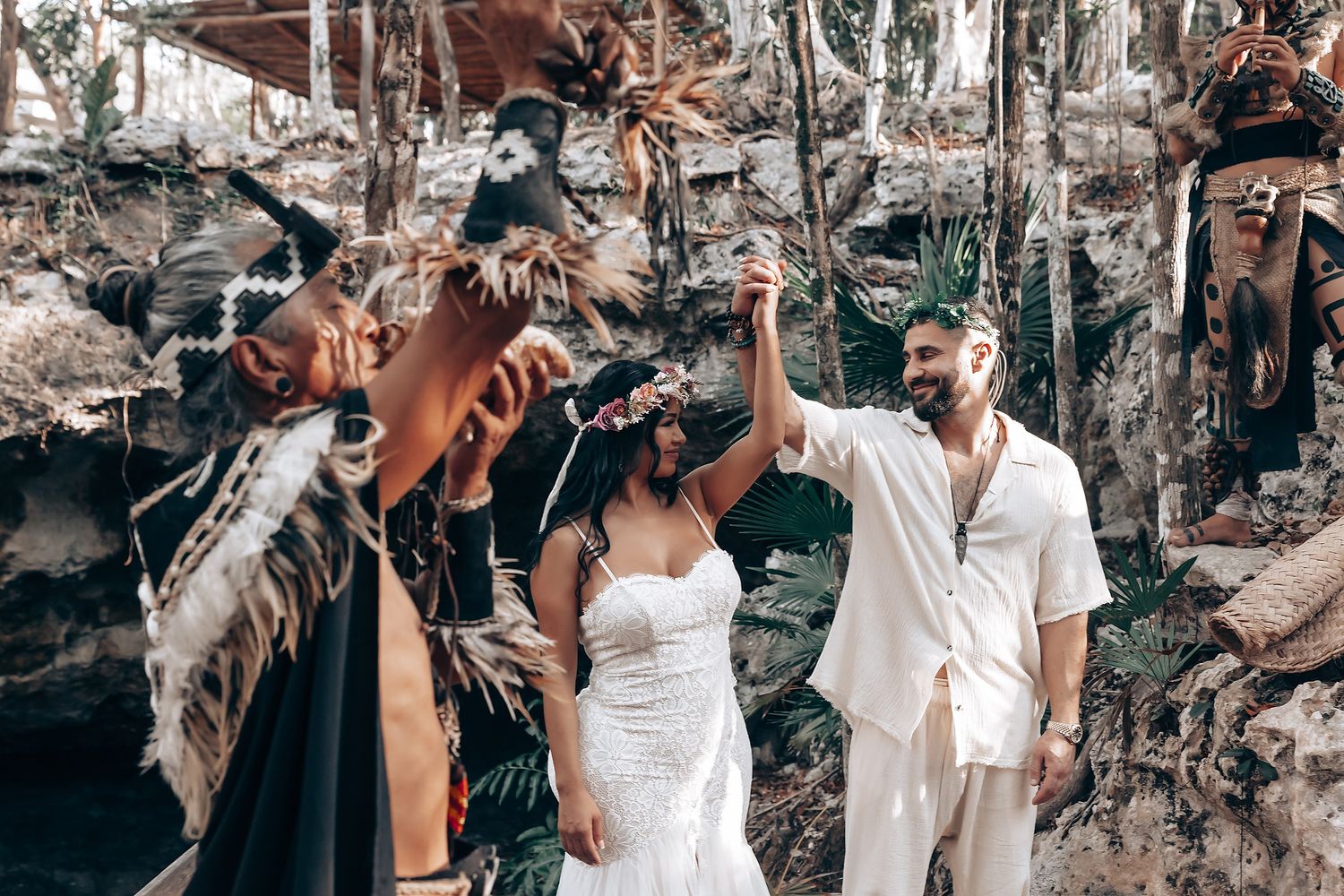 A joyous wedding celebration with ceremonial elements in a natural forest setting.