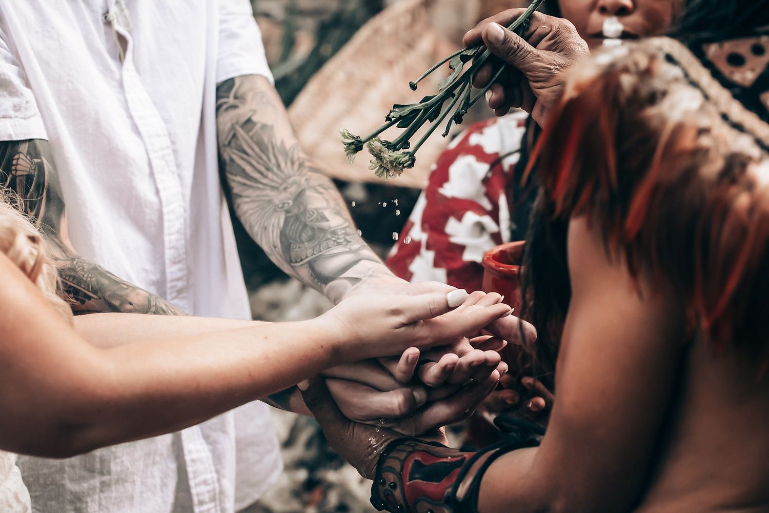 Couple in a rustic outdoor setting sharing intimate moments during a wedding photo session.
