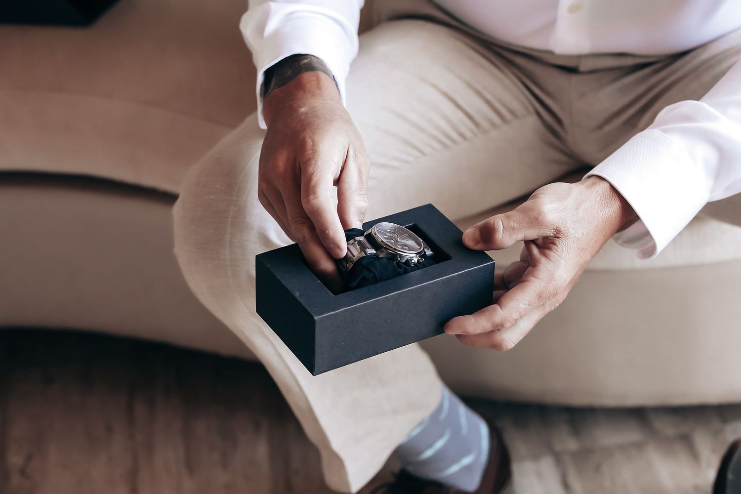 A person's hands are holding a remote control device.