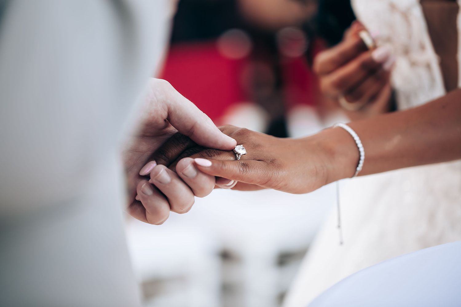 Wedding preparation details showing delicate lace dress and jewelry accessories.