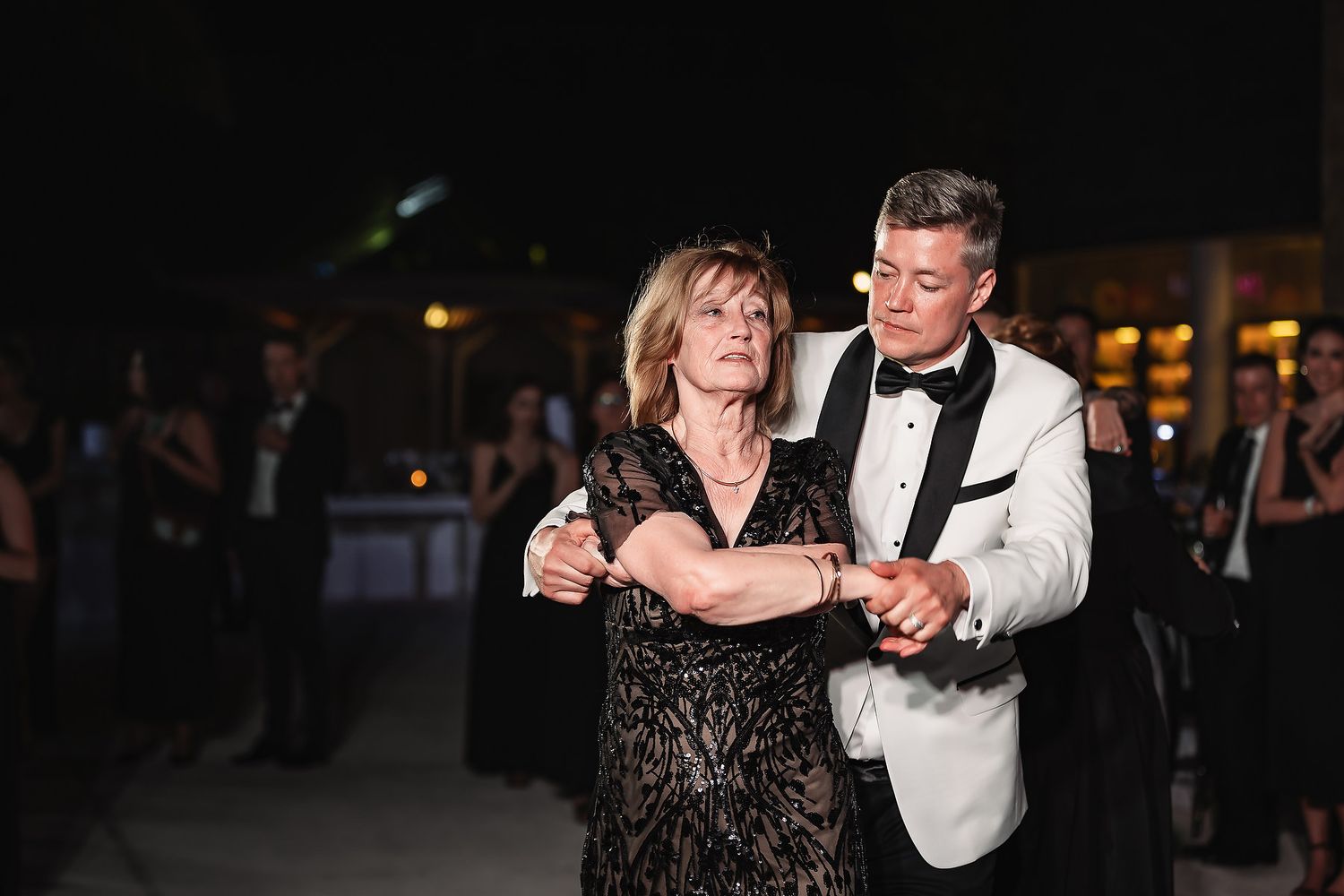 Couples dancing together in formal attire at an elegant evening event.