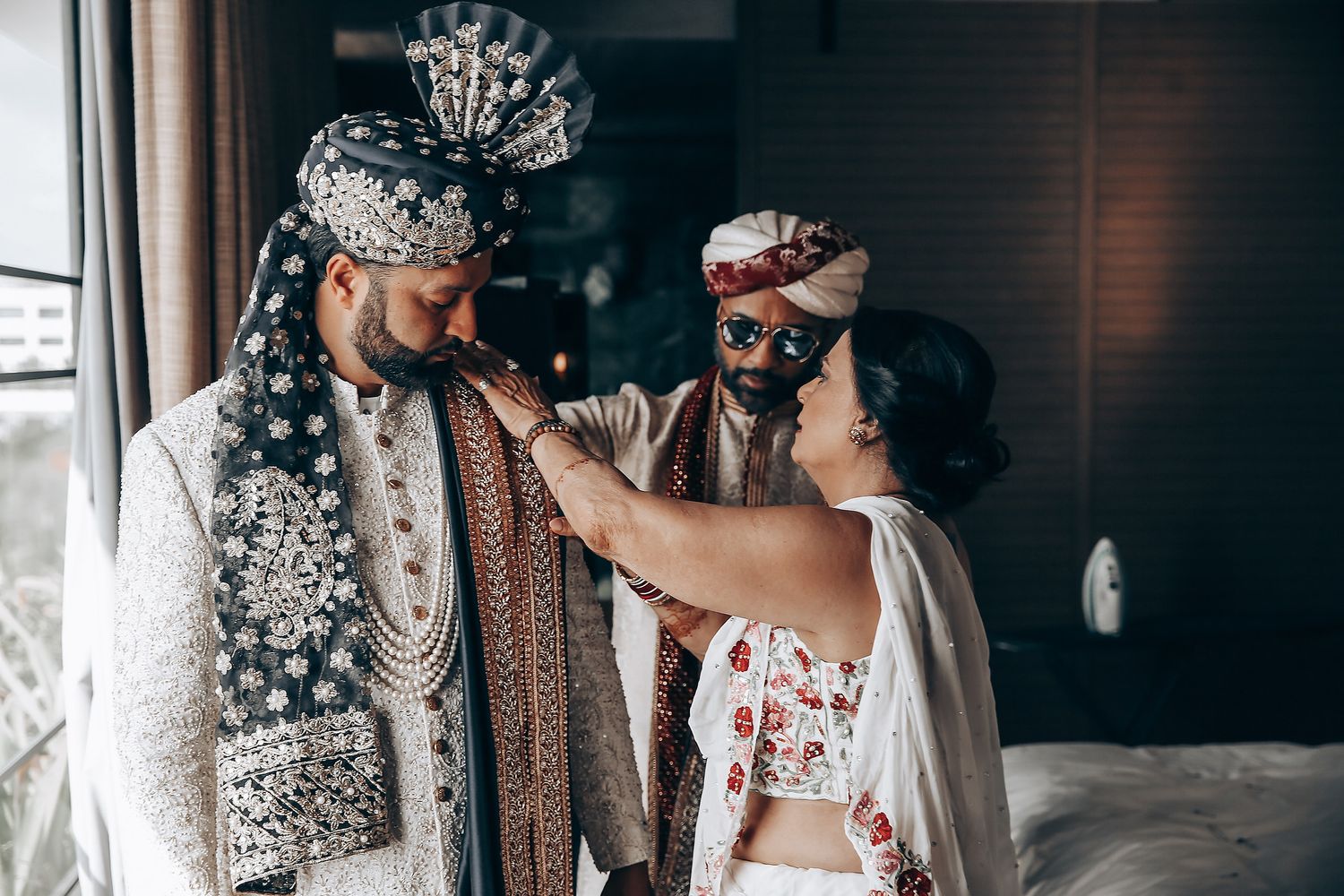 A couple in traditional Indian wedding attire share an intimate moment during their celebration.