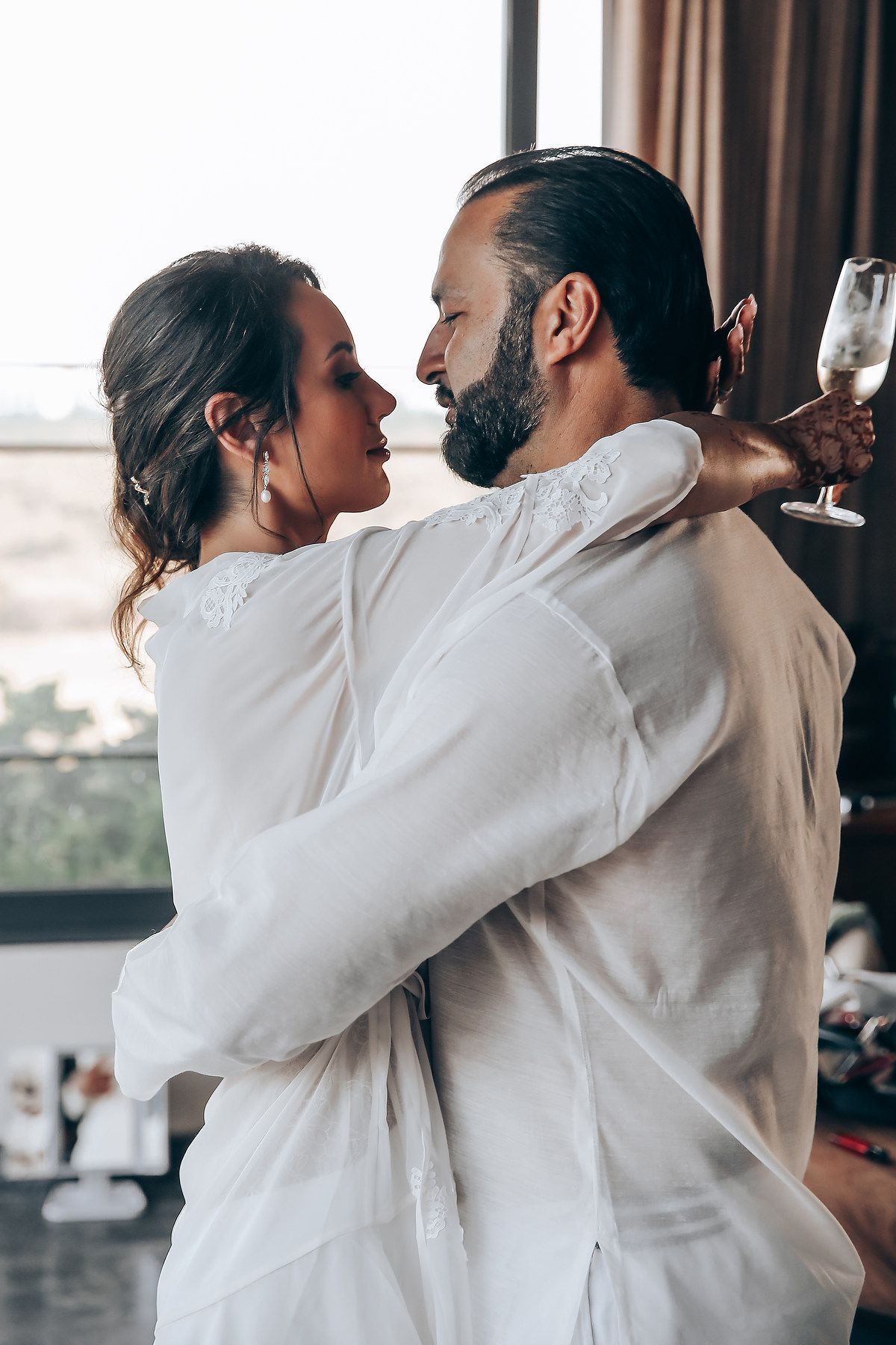 Series of romantic dance moments showing a couple in white embracing and swaying together.
